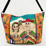 Day of the Dead American Gothic skeleton design silkscreened in bright colors, on cotton handbag with black cotton strap, shown against white background.