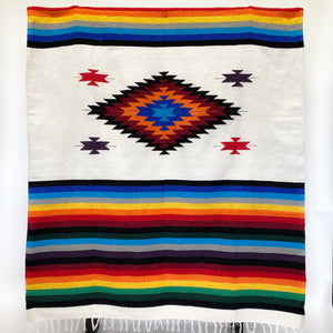 Mojave blanket Mexican-style woven in diamond and stripe design with bright rainbow colors on natural colored background
